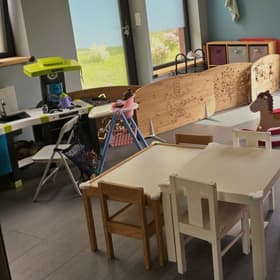 La pièce de vie des enfants : coin dinette, paravents en bois et petites tables